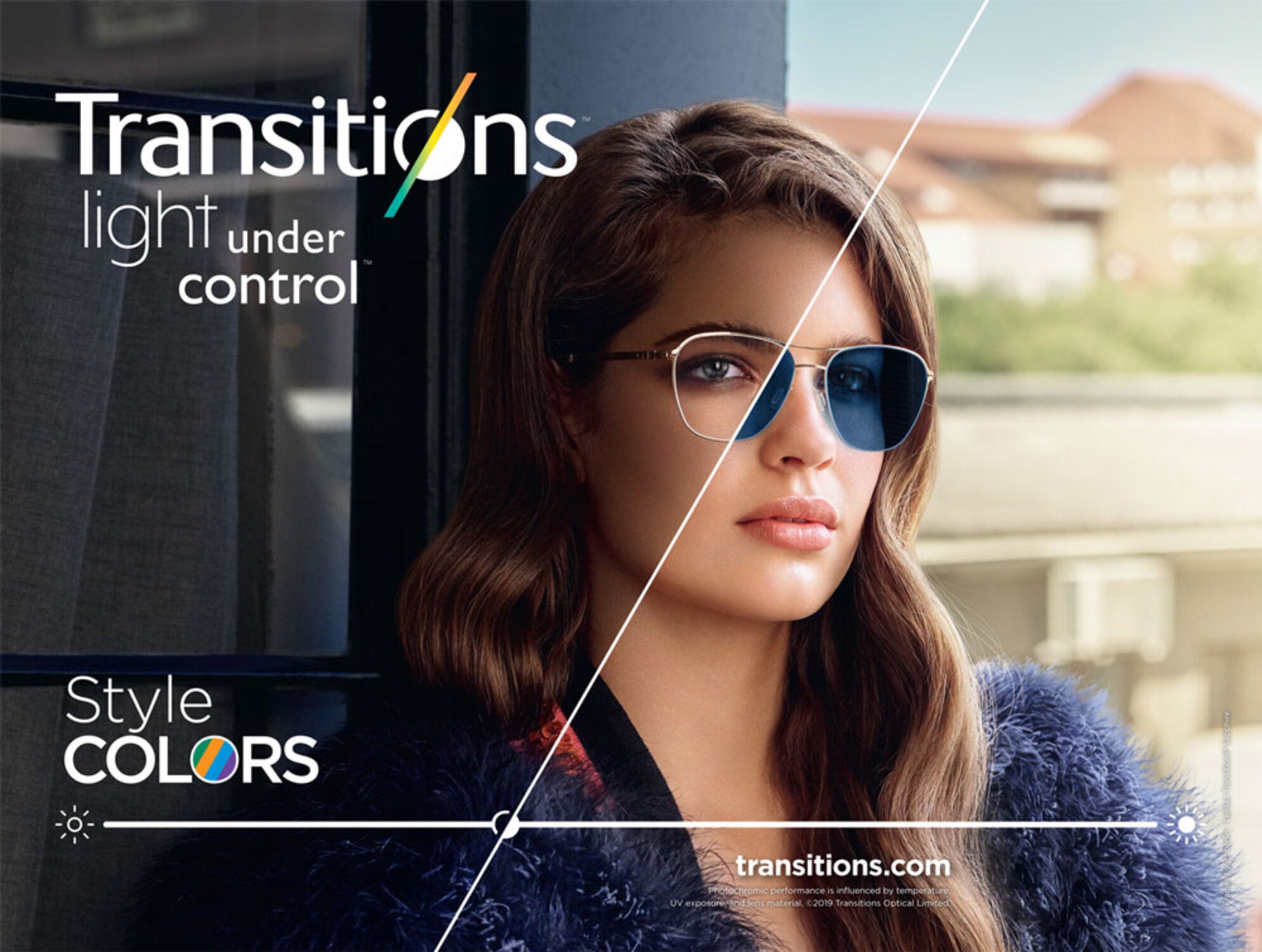 A woman with wavy brown hair wears glasses—clear on the left, blue-tinted on the right—demonstrating 1.5 TRANSITIONS for UV protection. Text: Transitions light under control. Style Colors. Blurred outdoor background.